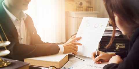 Lawyer showing information to client.