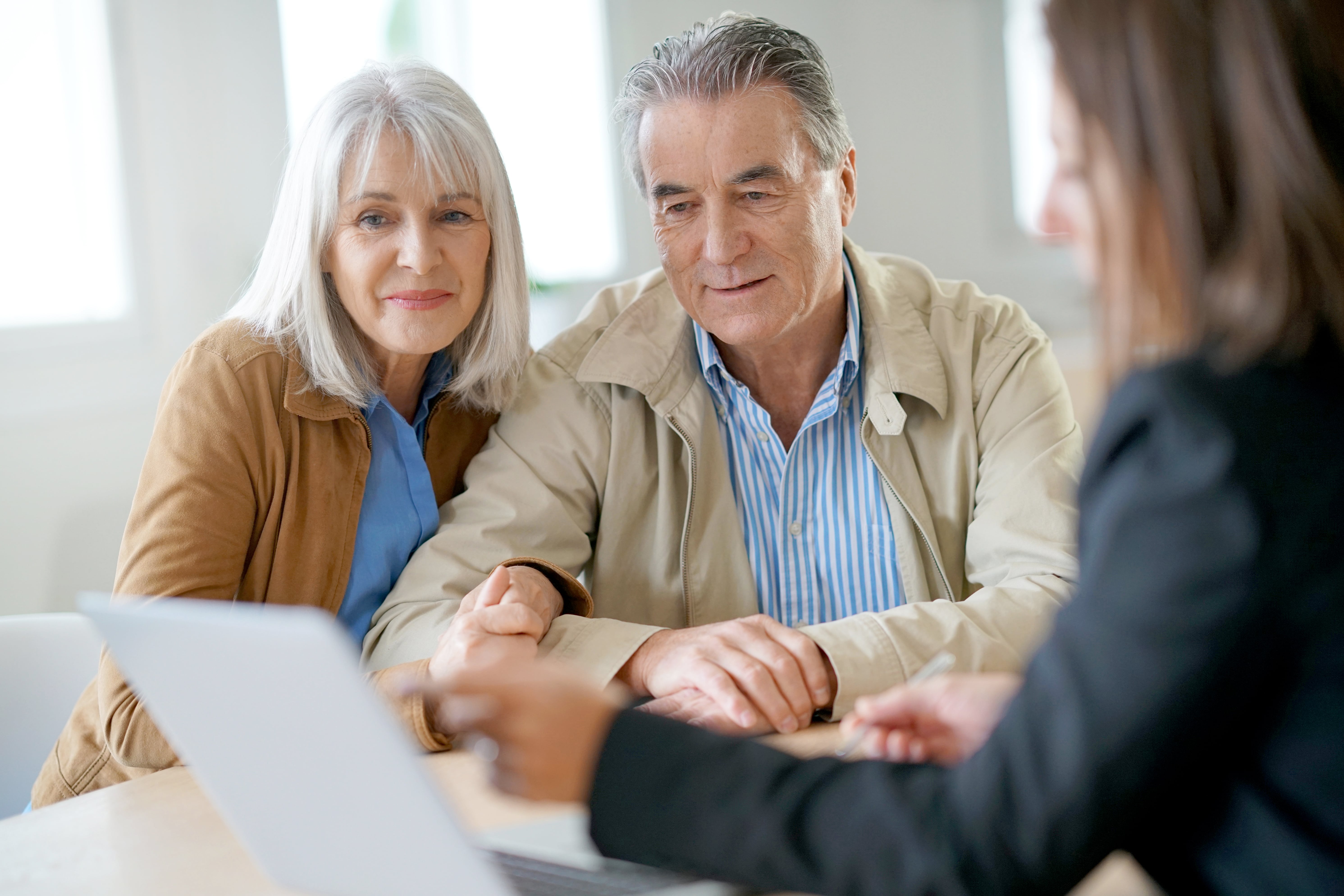 couple looking over estate planning document with lawyer